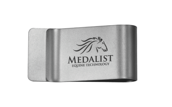 Silver metal business card holder with engraved horse logo and the text "Medalist Equine Technology" on a green background with a Pet Clip.