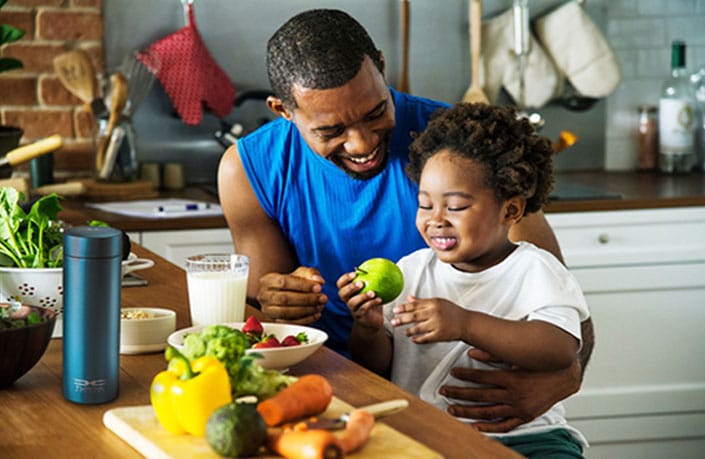 Father and child eating healthy food